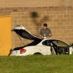 man and a white car